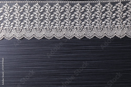 White lace on black table, top view. Space for text