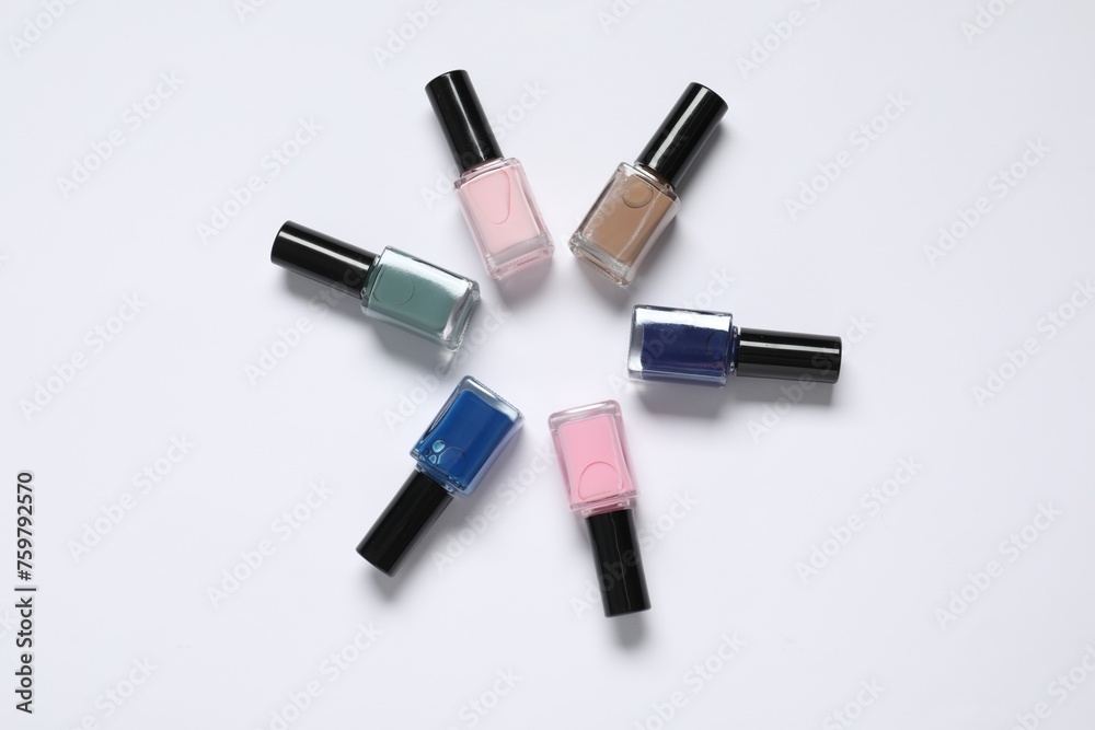Nail polishes on white background, flat lay Nail polishes on white background, flat lay