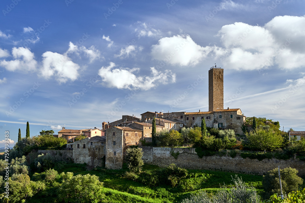 stone houses, bell tower and medieval tower on top of a hill in the town of Pereta in Tuscany