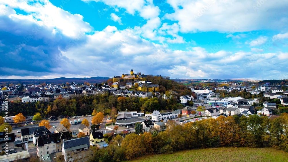  Aerial view around the old town of the city Montabauer on a cloudy day in autumn in Germany.