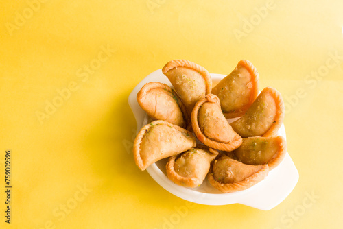 Gujia or Gujiya is a traditional Indian sweet or dessert made during Holi ,Diwali Festival.Resembles Spanish Empanada is deep fried or baked.Made from floor,milk solids,sugar,raisins,semolina.Closeup.