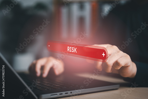 Business risk control and strategy management. Hand point on red bar of business risk level , decision making and risk crisis analysis. Measuring risky level bar virtual. photo
