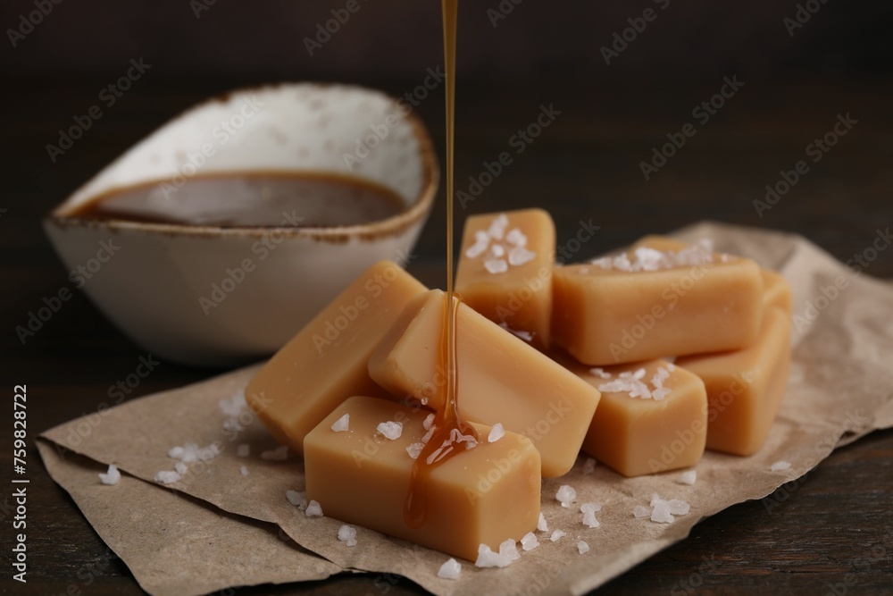 Pouring caramel on candies with sea salt at table, closeup