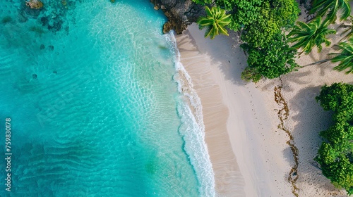 Aerial shot of a serene tropical beach with crystal clear turquoise waters, white sand, and lush greenery. 
