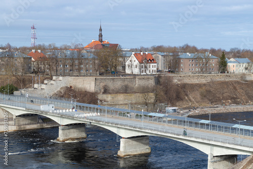 Border Friendship Bridge in the city landscape on a March day. Narva, Estonia photo