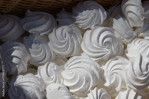 Set of white sweet merengues in the basket