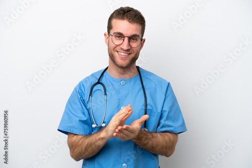 Young surgeon doctor caucasian man isolated on white background applauding after presentation in a conference