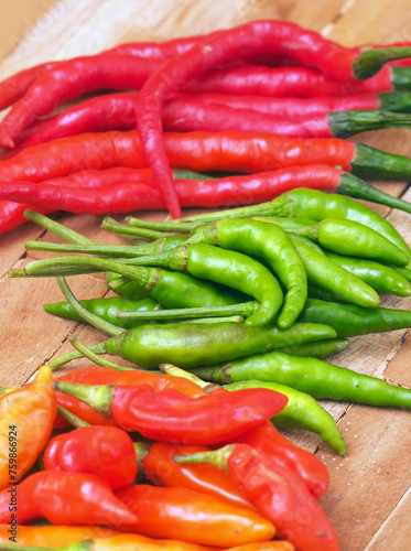 Three type of Red and green raw chilli in cutting board  (ID: 759866924)