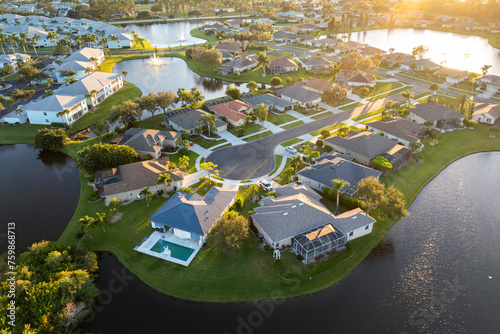 Low-density private homes at sunset. Rural street cul-de-sac dead end in residential suburbs with upscale suburban houses outside of Sarasota, Florida