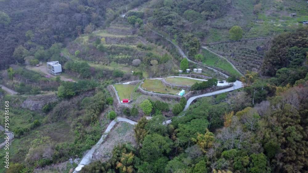 A rural landscape with winding roads and scattered buildings, aerial view A rural landscape with winding roads and scattered buildings, aerial view