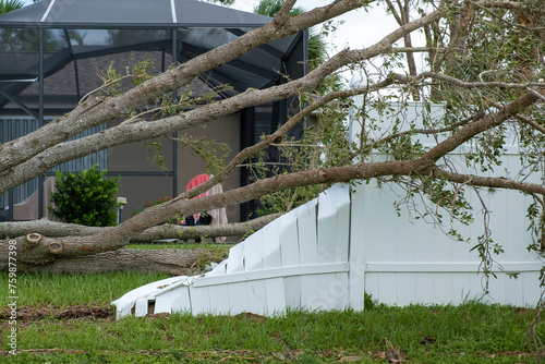 Obraz na płótnie White plastic backyard fence damaged after hurricane winds in Florida