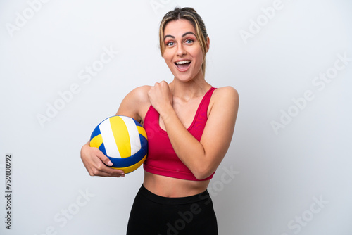 Young caucasian woman playing volleyball isolated on white background celebrating a victory