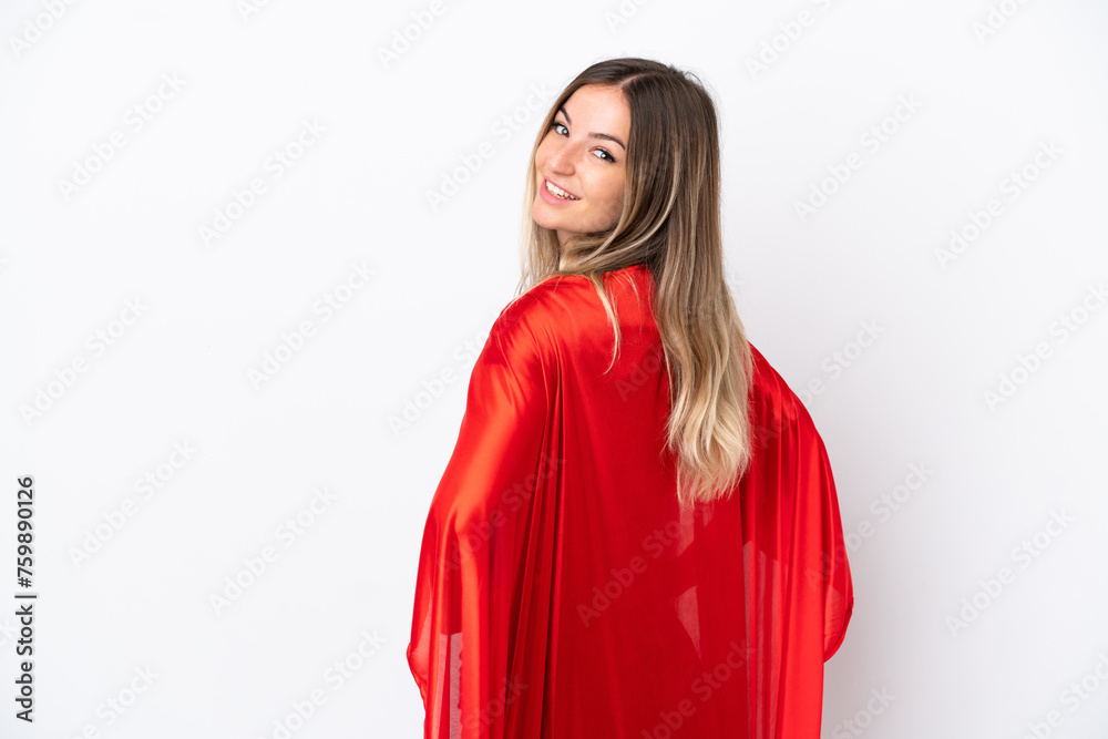 Young Romanian woman isolated on white background in superhero costume and doingposing with arms at hip and smiling