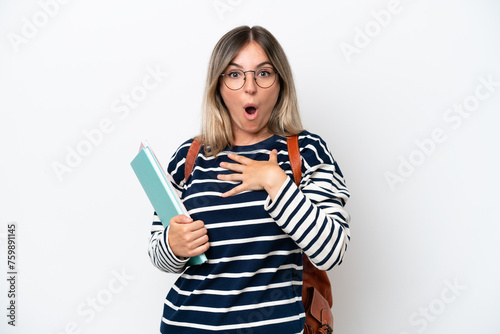 Young student Rumanian woman isolated on white background surprised and shocked while looking right