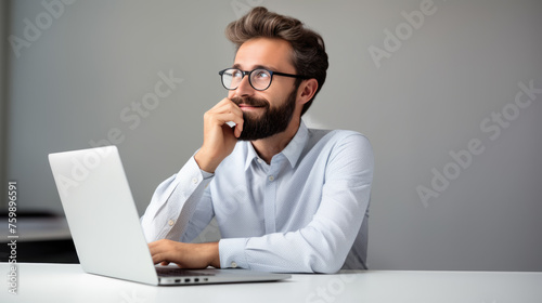 Middle aged man working on a laptop in his modern office © MP Studio