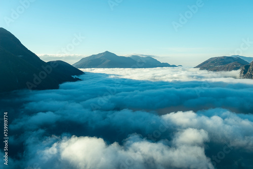 Mountain Peak Above Cloudscape with Sunlight and Clear Sky in Lugano, Ticino in Switzerland.