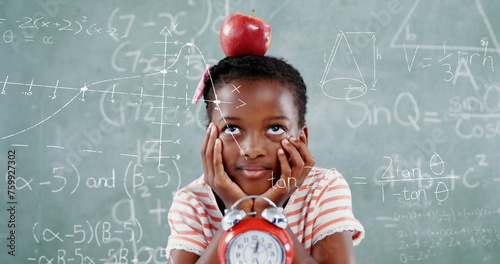 Image of math formulas over thoughtful african americna girl with apple over blackboard photo