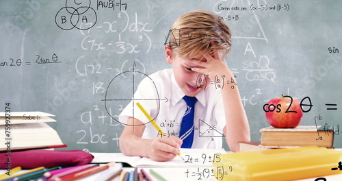 Image of math formulas over focused caucasian boy doing homework