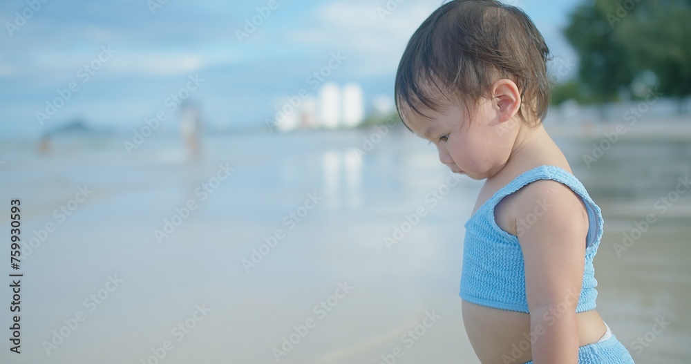 A curious toddler explores the sandy beach, captivated by the gentle waves lapping at the shore under the warm sunlight, embodying innocence and discovery A curious toddler explores the sandy beach, captivated by the gentle waves lapping at the shore under the warm sunlight, embodying innocence and discovery