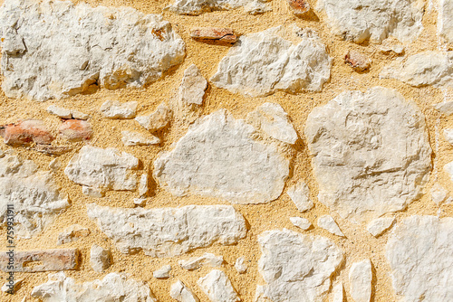 Background. An ancient wall made of archaically processed stone. The wall of the ancient building is made of stones. photo