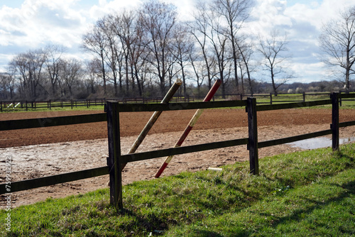 Jumping obstacles for horses. They are leaning against the railing.
