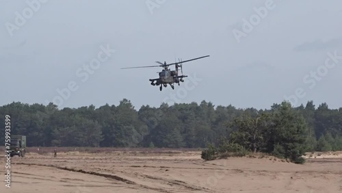 Military Helicopter flying low between trees photo