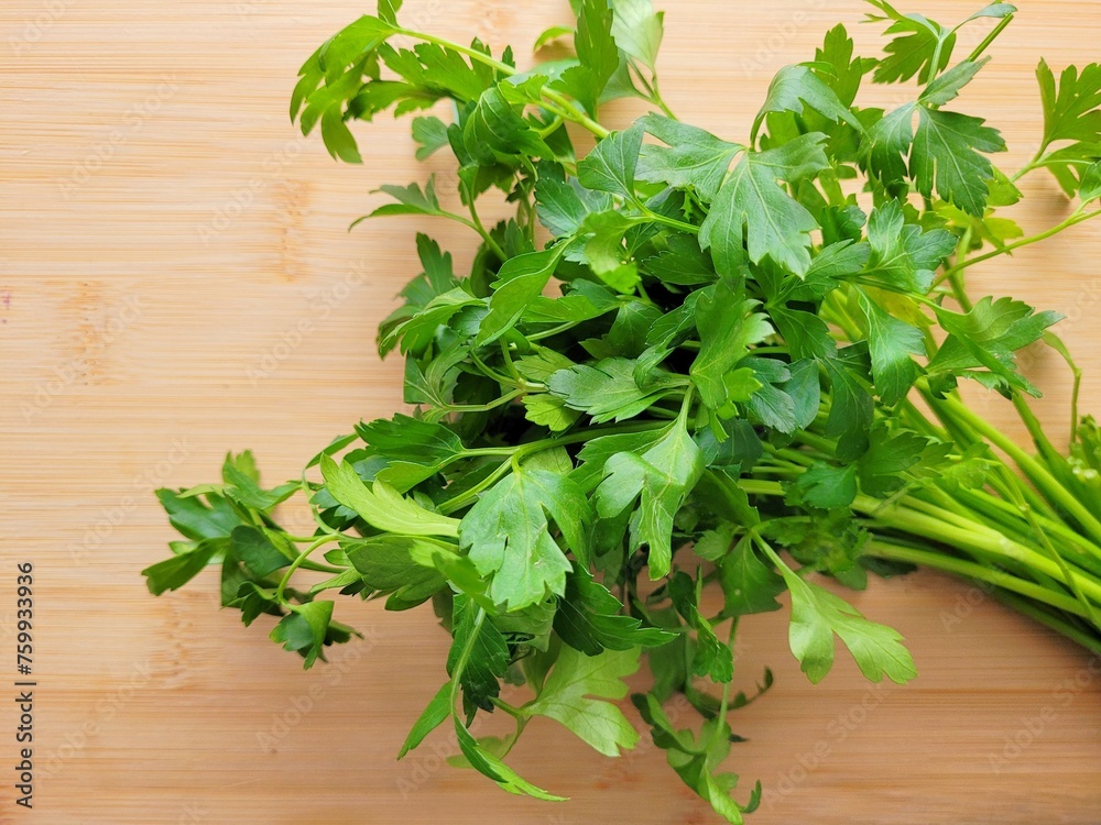 Bunch of lovage leaves on wooden background. Bunch of lovage leaves on wooden background.