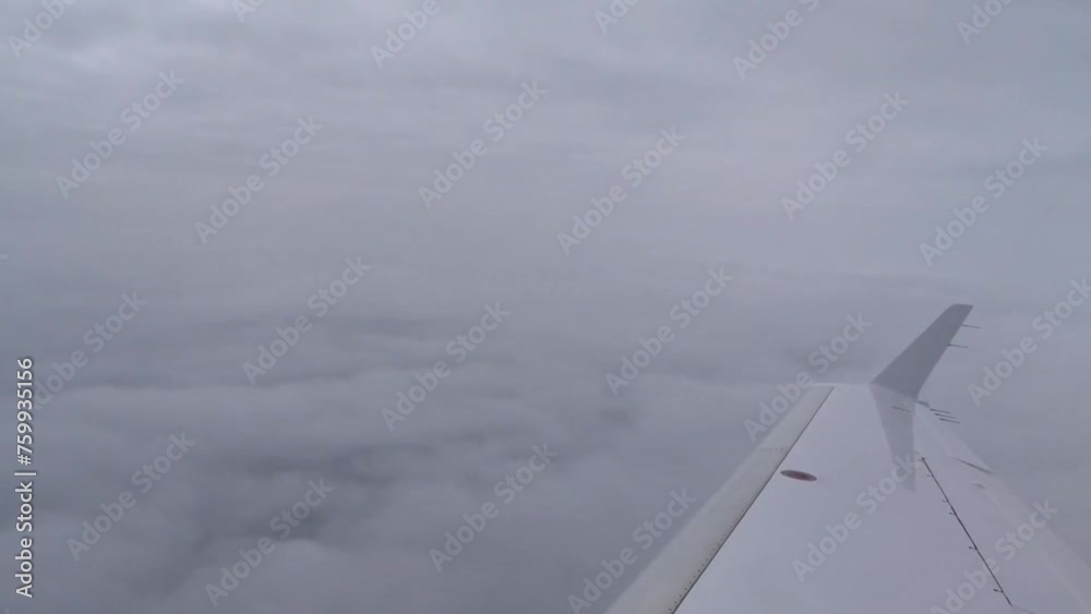 Airplane Wing Seat View on Clouds in between Airplane Wing Seat View on Clouds in between