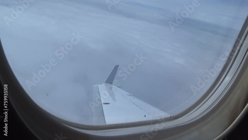 Airplane Window View While Turning Sideways (private jet embraer phenom 300) photo