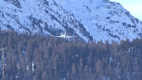 Business Jet Final Approach into Executive Airport Mountain Snow Trees Background Generic Unmarked White photo