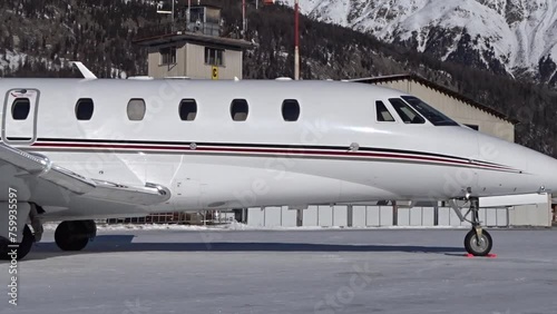Slow panning shot of Business Jet parked at Airport Snow photo