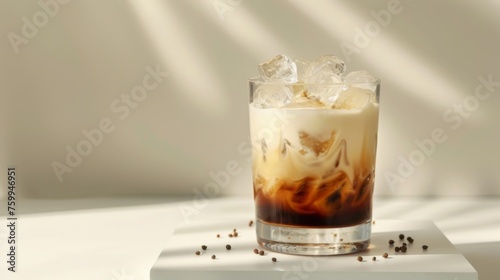 White Russian cocktail on podium on yellow background. Glass of alcoholic drink photo