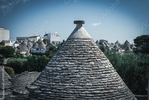 The typical Trulli of Alberobello. Medieval white stone houses created to protect from the heat of the southern italy summer. photo