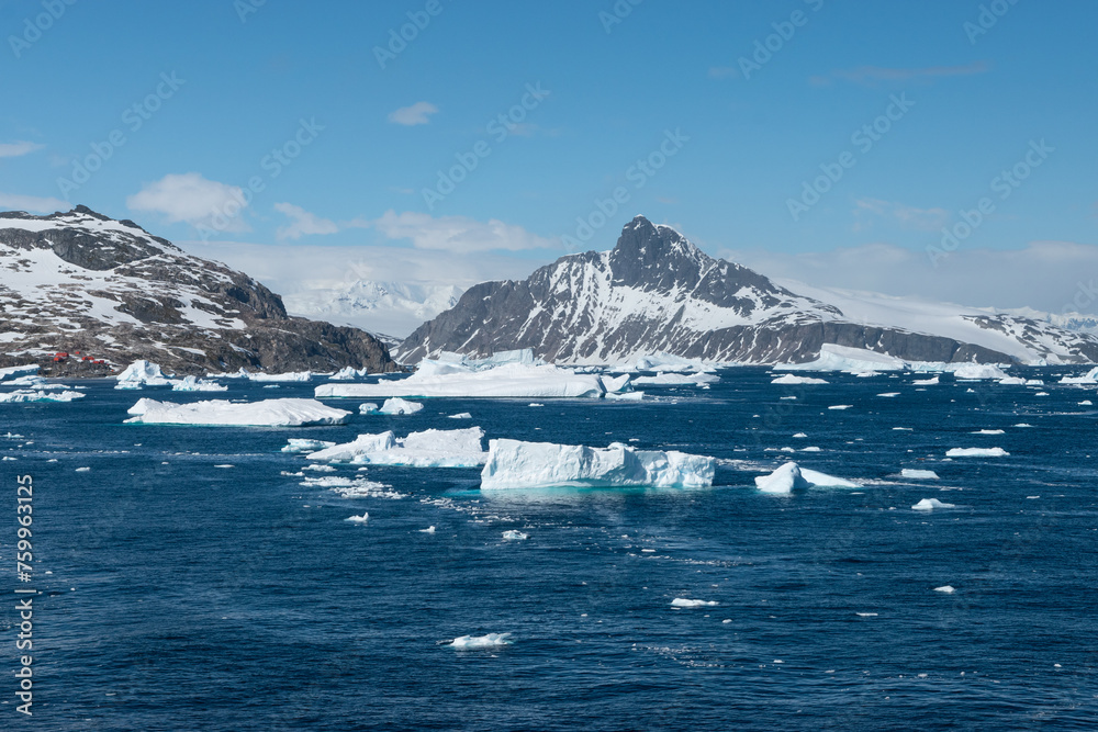 Antarctica mountain landscape with floating ice on the sea.