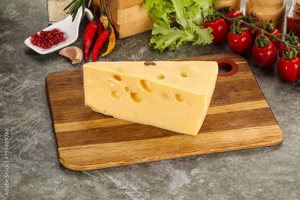 Swiss Maasdam cheese triangle over board Swiss Maasdam cheese triangle over board
