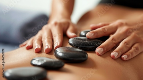 Close-up of a woman having a hot stone massage in spa salon