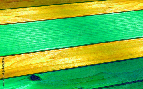 At an angle a wooden table made of spruce boards , painted with light green yellow paint