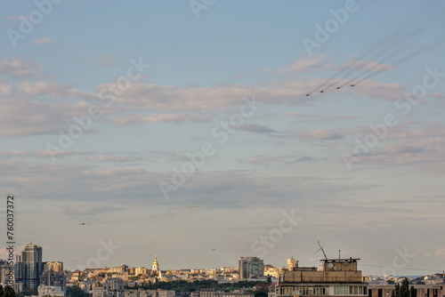 Kyiv aerial summer cityscape with flying military airplanes, Ukraine.