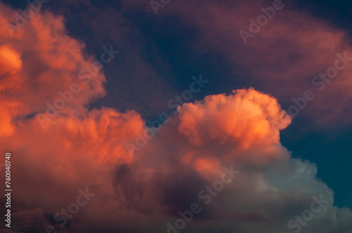 Dramatic sunset sky with vibrant orange clouds. © Andrii_Abriutin