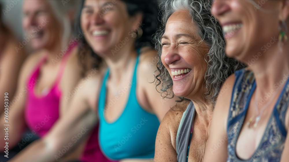 Fototapeta premium Elderly women laughing and sitting together in yoga studio.