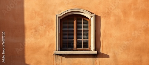A rectangular brown wood window fixture is embedded in the brickwork of the building, stained with tints and shades of wood