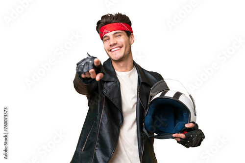 Young caucasian man with a motorcycle helmet over isolated background pointing front with happy expression