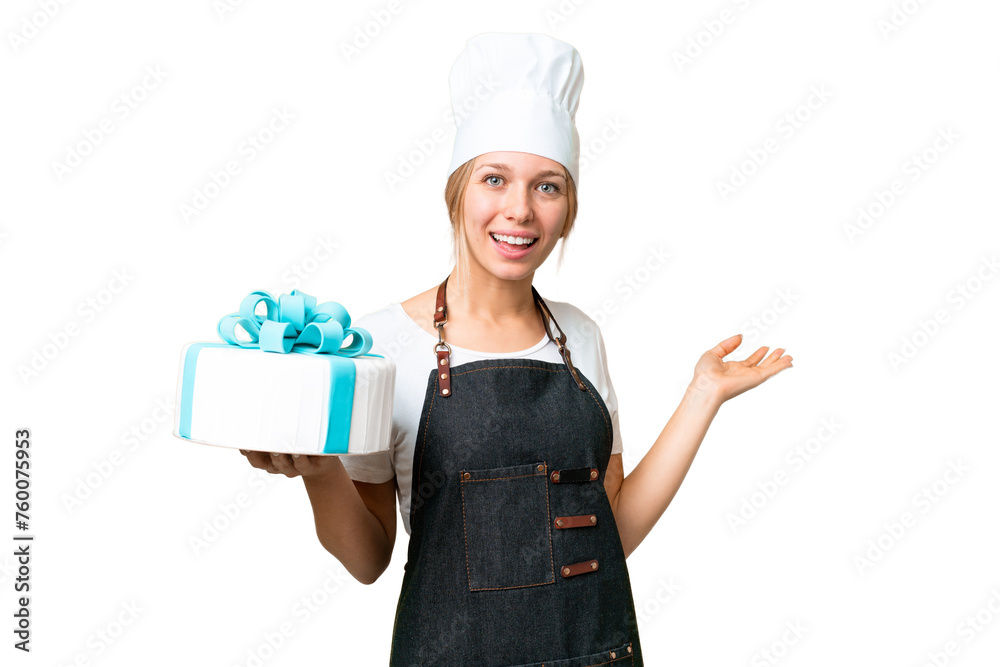 Young pastry blonde woman with a big cake over isolated chroma key background extending hands to the side for inviting to come Young pastry blonde woman with a big cake over isolated chroma key background extending hands to the side for inviting to come