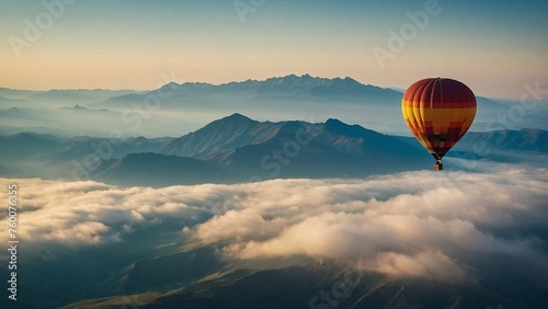 Hot air balloon rising above the clouds, casting a shadow on a vast mountain landscape. Travelling in balloon.