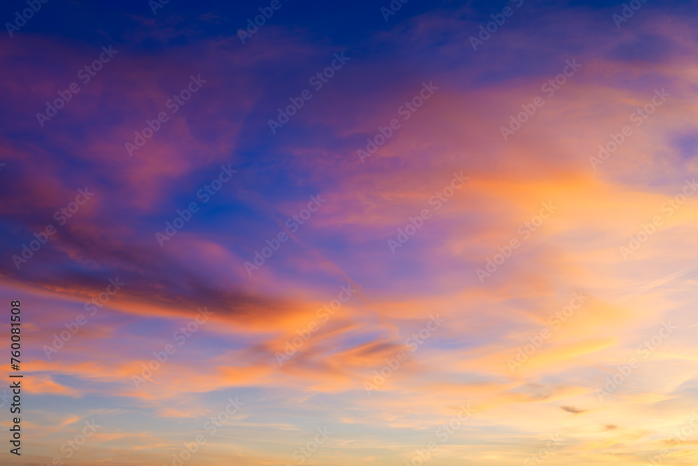 Pink clouds during sunset. Blue sky. Sunshine. A huge clouds in the sky after a storm. Natural landscape. Wallpaper and background.