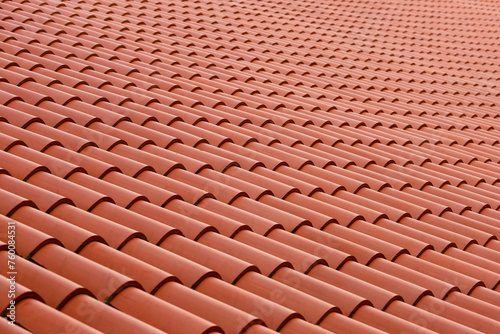 Roof made of tiles. Repeating tile elements. Painting tiles from a beautiful angle. Photo of the roof