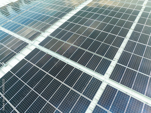 Power plant using renewable solar energy with sun. aerial view of solar panels