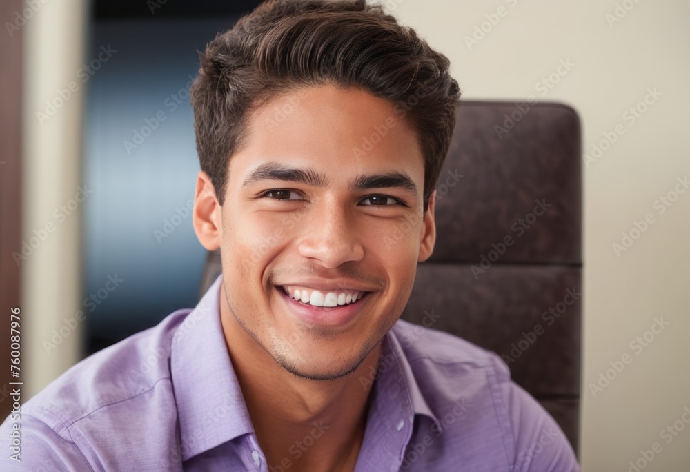Smiling young man in lavender shirt with digital device. Casual and friendly office scene. Smiling young man in lavender shirt with digital device. Casual and friendly office scene.