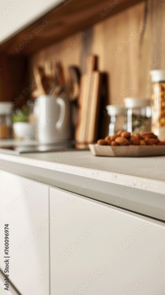Blurred kitchen interior with focus on a plate of almonds on the countertop. Cozy home concept with selective focus for design and print