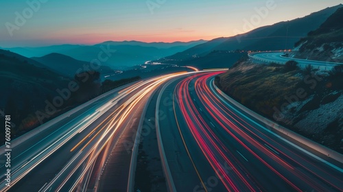 Motion blur from cars driving on a winding scenic road at twilight